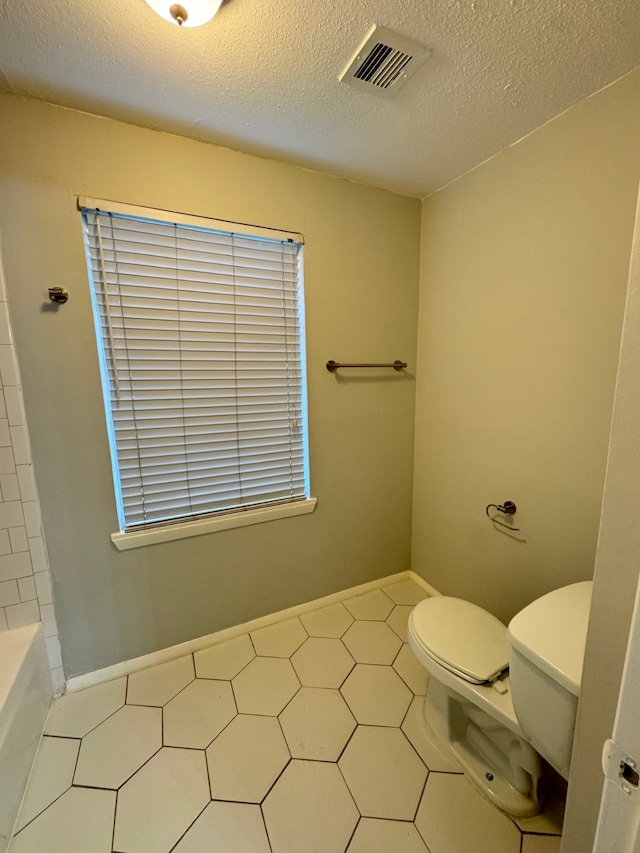 9809 Richmond Ave Unit J1, Houston, TX 77042 - full bathroom with a bathtub, a textured ceiling, and a shower