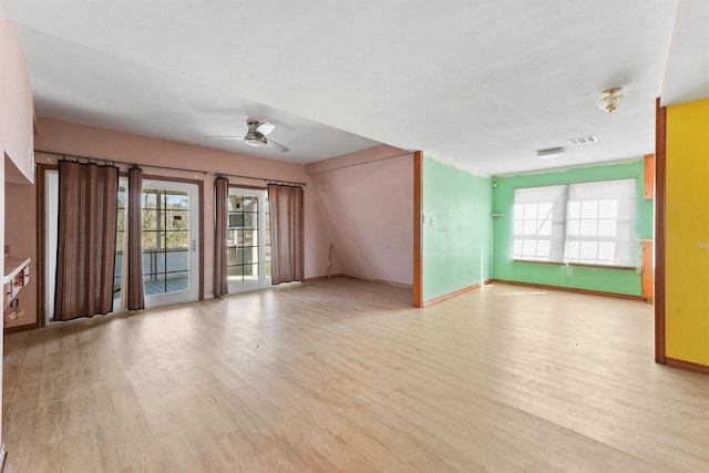 unfurnished living room with ceiling fan, baseboards, visible vents, and light wood-style floors