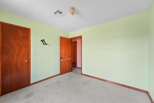 unfurnished bedroom with baseboards, visible vents, and light colored carpet