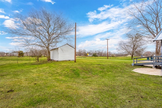 view of yard featuring an outbuilding and a storage unit