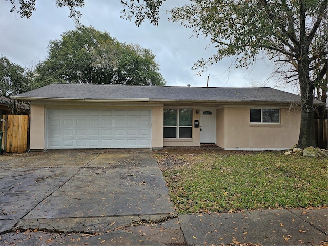 single story home featuring driveway, an attached garage, and stucco siding