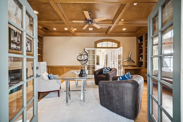 interior space with built in shelves, french doors, a ceiling fan, light wood-type flooring, and coffered ceiling