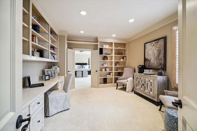 office with ornamental molding, plenty of natural light, built in study area, and light colored carpet