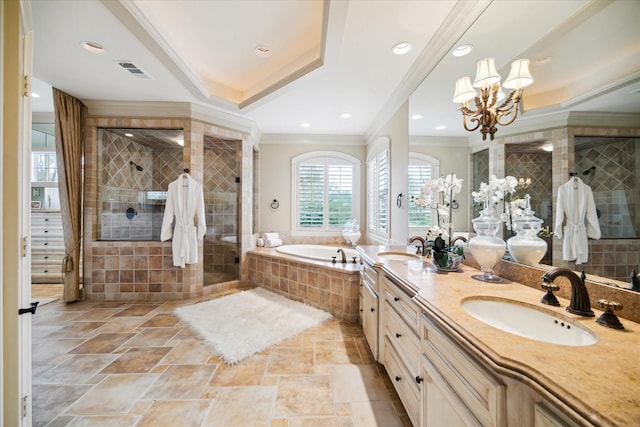 full bath with a sink, a notable chandelier, crown molding, a shower stall, and a bath