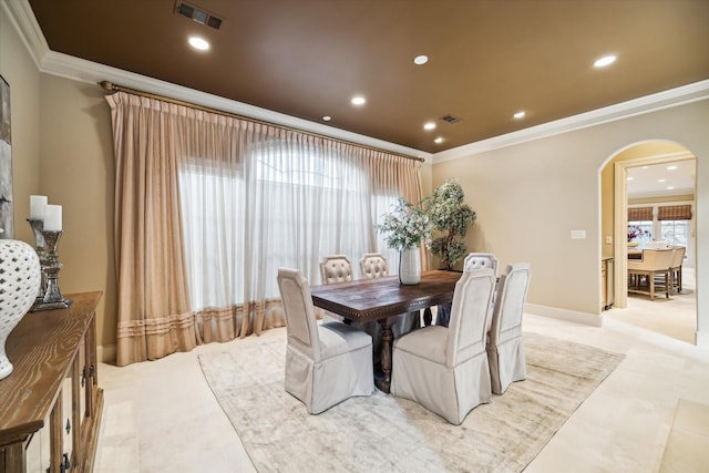 dining space with arched walkways, ornamental molding, visible vents, and recessed lighting