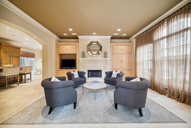 living room featuring arched walkways, ornamental molding, a fireplace, and recessed lighting