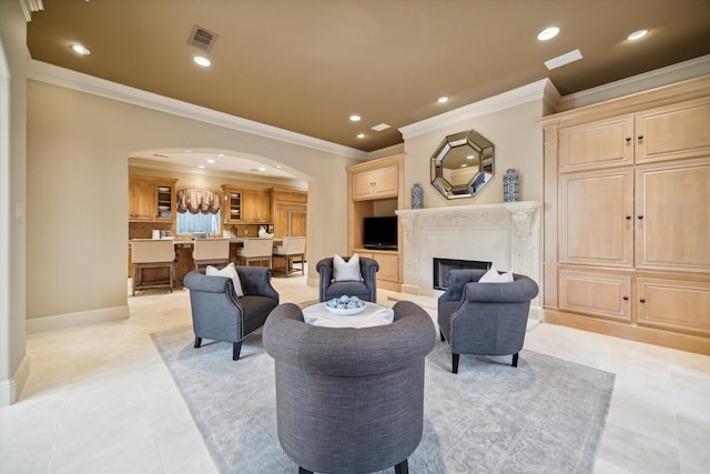 living area featuring arched walkways, light tile patterned floors, recessed lighting, a premium fireplace, and visible vents