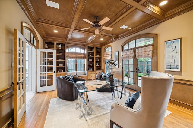 office space featuring light wood-type flooring, ornamental molding, coffered ceiling, and french doors