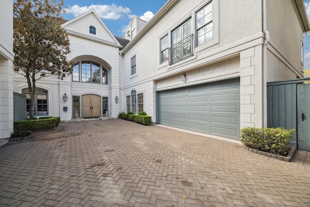 view of front of property with decorative driveway and stucco siding