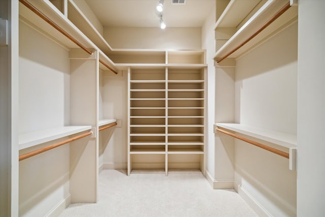 spacious closet with light carpet and visible vents