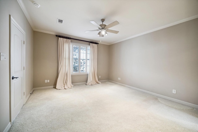 empty room featuring light carpet, ceiling fan, ornamental molding, and visible vents