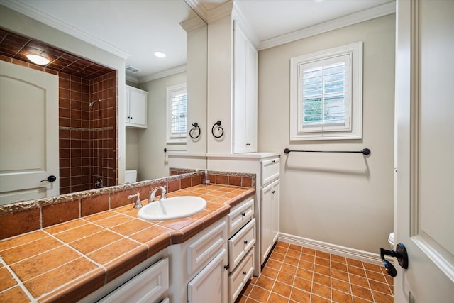 full bath with toilet, ornamental molding, vanity, baseboards, and tile patterned floors