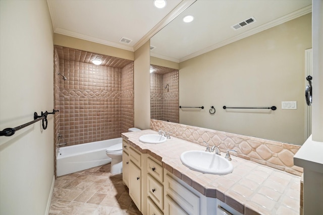 bathroom featuring toilet, visible vents, a sink, and ornamental molding