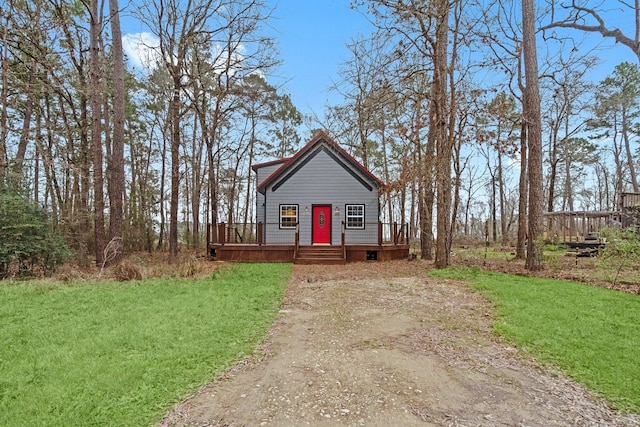 view of front facade with a front lawn and a wooden deck
