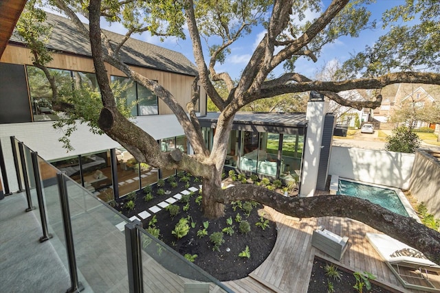 exterior space featuring a fenced backyard and an outdoor pool