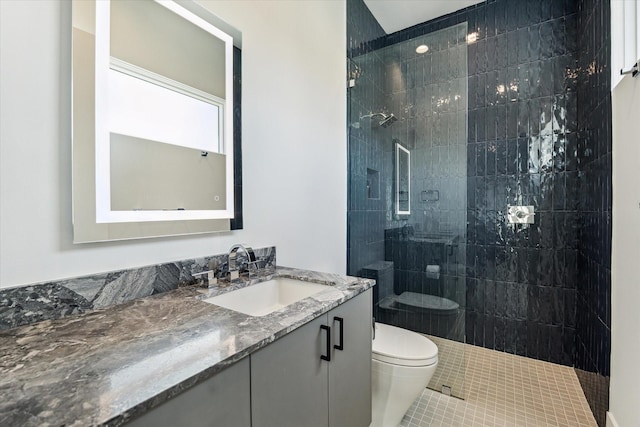 bathroom with a walk in shower, vanity, toilet, and tile patterned floors