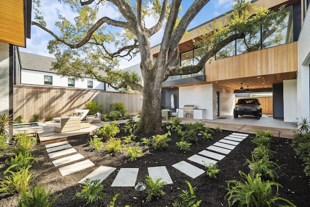 view of yard featuring fence and a wooden deck