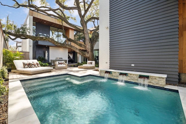 outdoor pool with outdoor lounge area and a patio