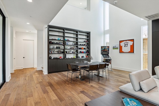 wine area with light wood finished floors, baseboards, visible vents, and recessed lighting