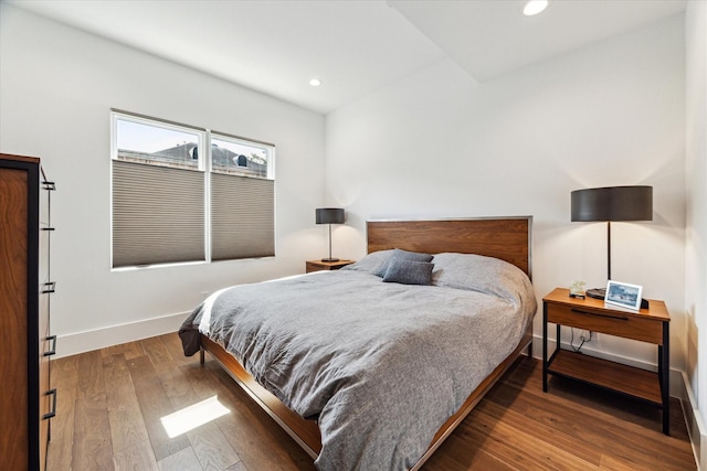 bedroom with recessed lighting, baseboards, and wood finished floors