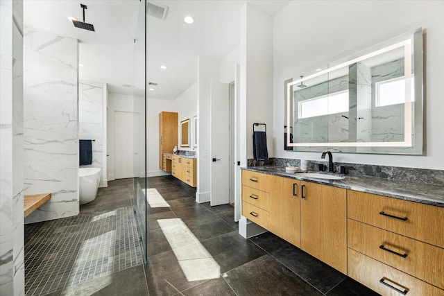 full bath with a freestanding tub, recessed lighting, visible vents, vanity, and a marble finish shower