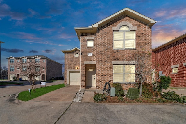 traditional home featuring brick siding and driveway