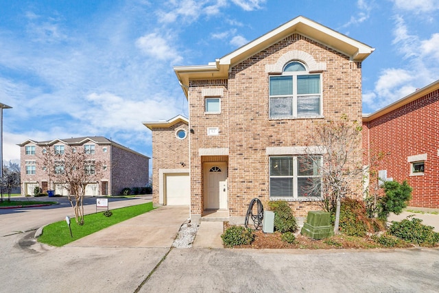 view of front of home with brick siding, concrete driveway, and a garage