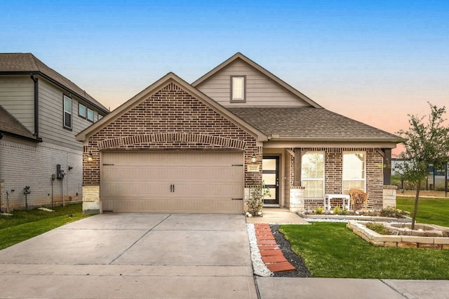 view of front of house featuring driveway, brick siding, an attached garage, and a shingled roof