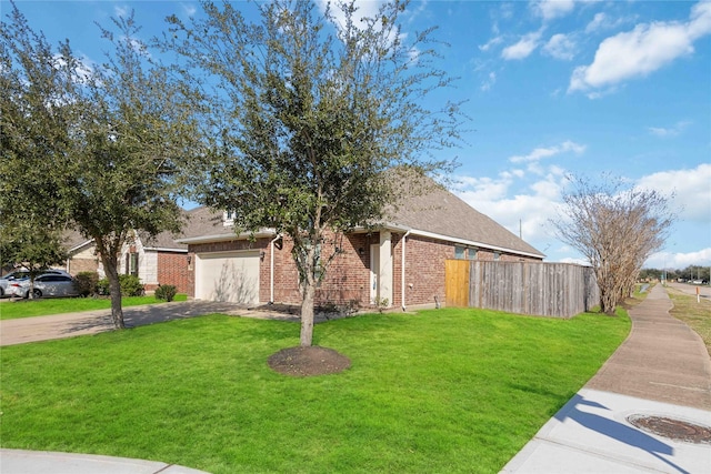 view of front of house with brick siding, driveway, a front lawn, and fence