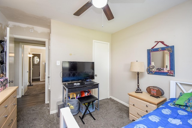 bedroom featuring baseboards, dark carpet, and ceiling fan