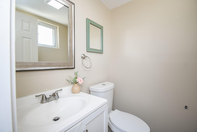 bathroom featuring toilet and vanity