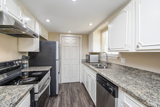 kitchen with light stone counters, stainless steel appliances, under cabinet range hood, white cabinetry, and a sink