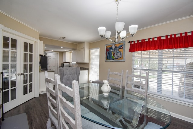 dining room featuring dark wood-style floors, ornamental molding, and a notable chandelier