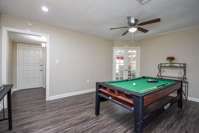 recreation room featuring a textured ceiling, baseboards, dark wood-style flooring, and french doors