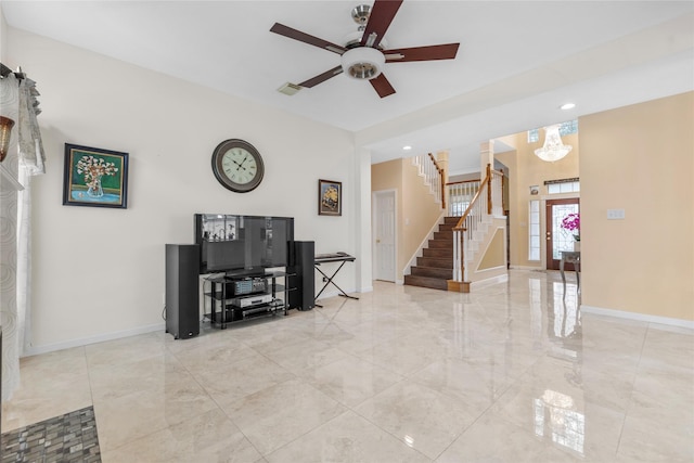 living room featuring ceiling fan, visible vents, baseboards, marble finish floor, and stairway