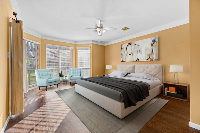 bedroom featuring baseboards, dark wood-type flooring, visible vents, and crown molding