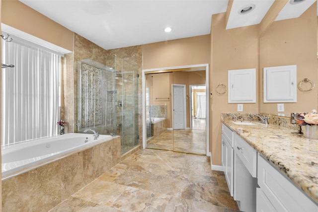 full bathroom featuring a garden tub, a shower stall, and vanity