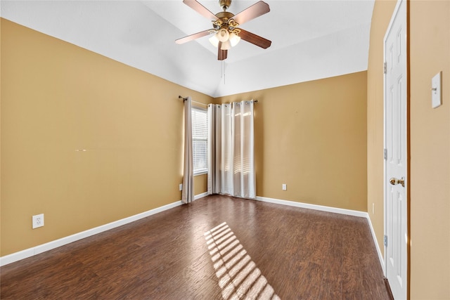 spare room with vaulted ceiling, ceiling fan, wood finished floors, and baseboards