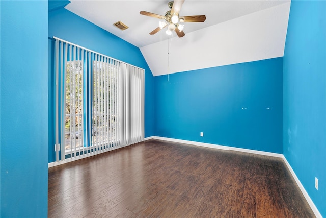 empty room featuring baseboards, visible vents, a ceiling fan, wood finished floors, and vaulted ceiling