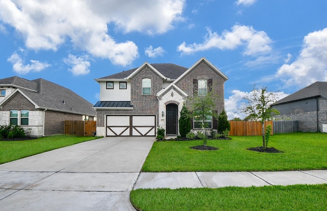 traditional-style house featuring a garage, driveway, a standing seam roof, fence, and a front yard