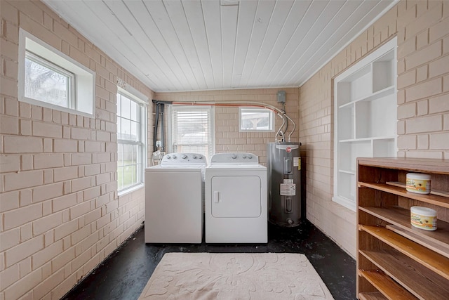 laundry room with a healthy amount of sunlight, wooden ceiling, washing machine and dryer, and water heater