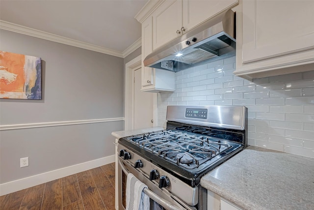 kitchen featuring crown molding, light countertops, white cabinets, stainless steel gas range, and under cabinet range hood