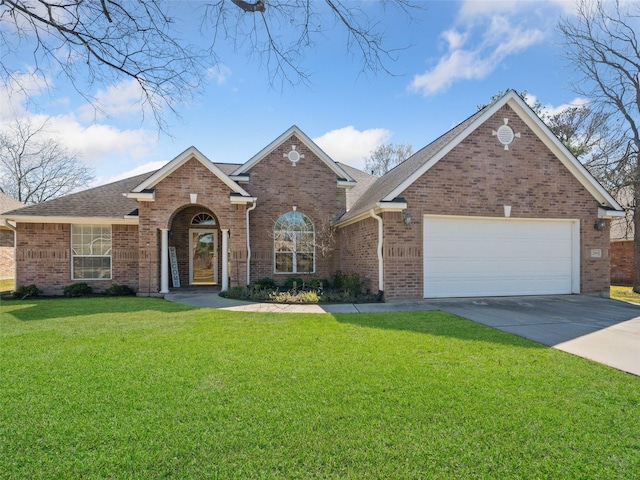 traditional home featuring driveway, a garage, roof with shingles, a front yard, and brick siding