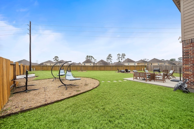 view of play area featuring a residential view, a fenced backyard, a lawn, and a patio