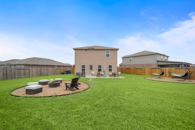 back of property with a yard, an outdoor fire pit, a patio, and a fenced backyard