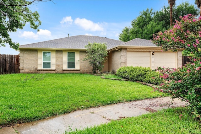 ranch-style house with a garage, brick siding, a front lawn, and fence