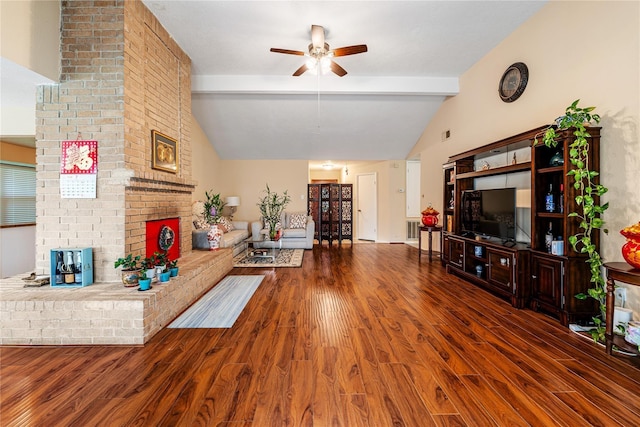 living area with vaulted ceiling with beams, ceiling fan, a fireplace, and dark wood-type flooring