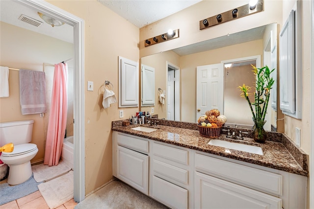 full bath featuring double vanity, shower / bath combo with shower curtain, a sink, and visible vents