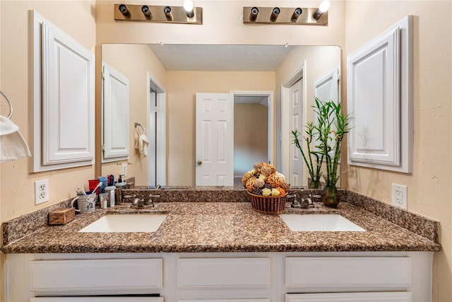 bathroom featuring a sink and double vanity