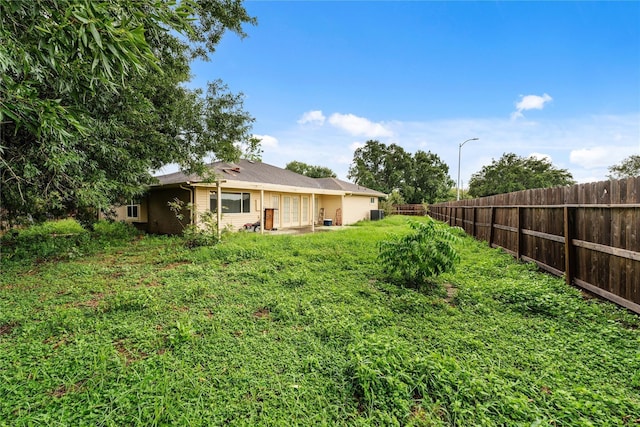 view of yard with a fenced backyard